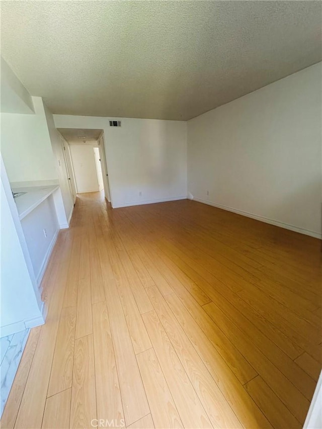 5484 Dobbs St Unit 132, Los Angeles, CA 90032 - empty room featuring a textured ceiling and light wood finished floors