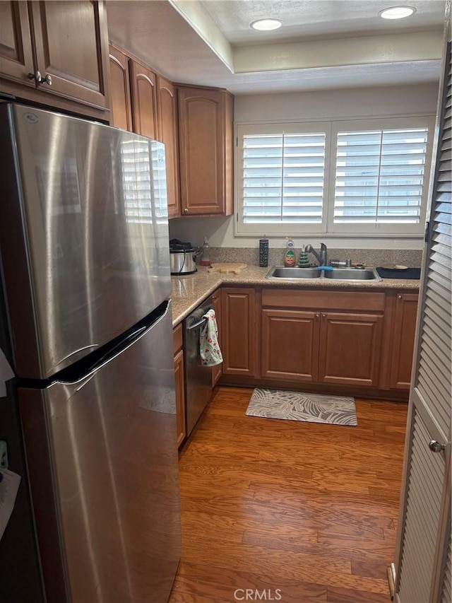 21086 Mauve Unit 79, Mission Viejo, CA 92691 - kitchen featuring stainless steel appliances, wood finished floors, light countertops, brown cabinets, and a raised ceiling