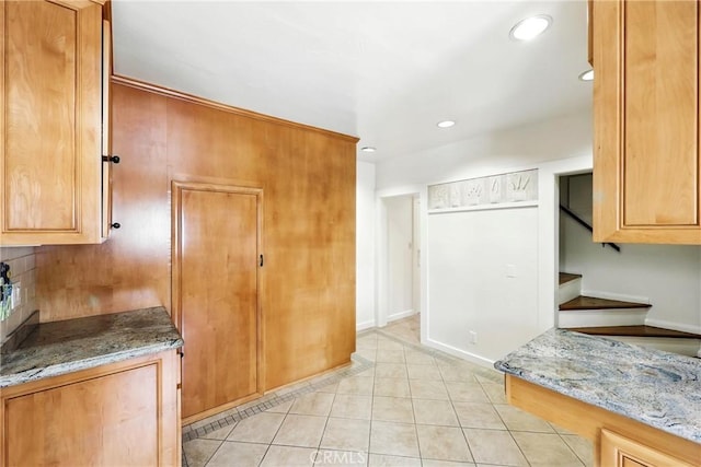 408 N Mccadden Pl, Los Angeles, CA 90004 - kitchen featuring light stone countertops, recessed lighting, light tile patterned floors, and brown cabinetry