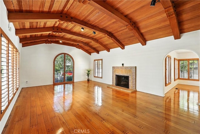 408 N Mccadden Pl, Los Angeles, CA 90004 - unfurnished living room featuring wood-type flooring, arched walkways, a premium fireplace, wood ceiling, and plenty of natural light