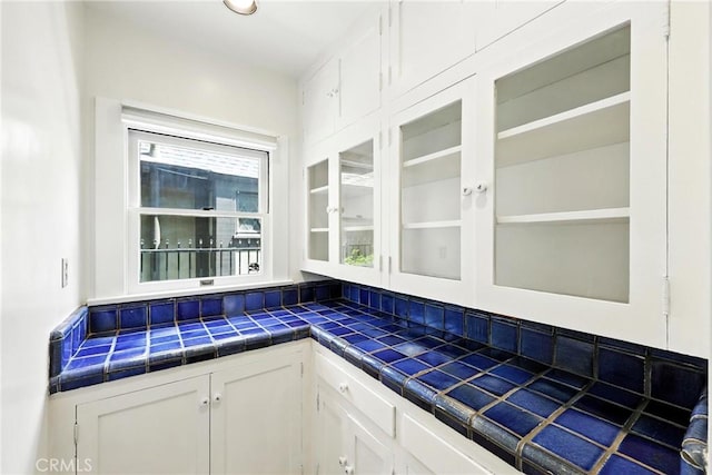 408 N Mccadden Pl, Los Angeles, CA 90004 - kitchen featuring white cabinetry, tile counters, and glass insert cabinets