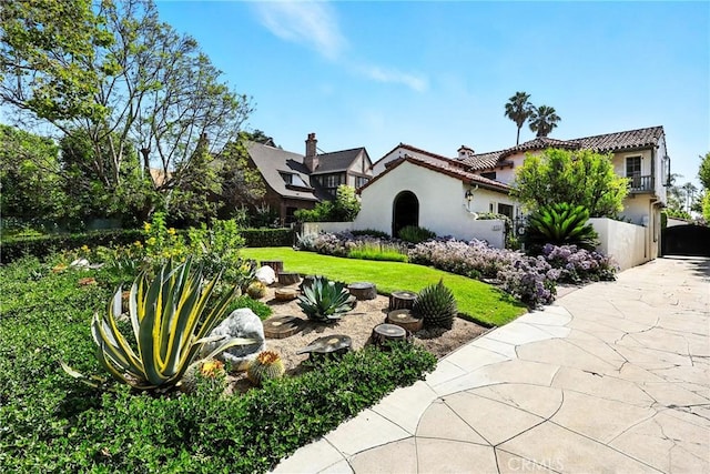 408 N Mccadden Pl, Los Angeles, CA 90004 - view of front of home featuring stucco siding, a tile roof, and driveway