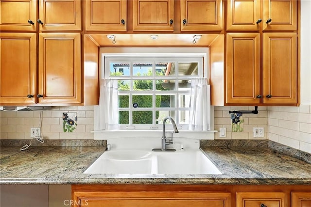 408 N Mccadden Pl, Los Angeles, CA 90004 - kitchen featuring brown cabinetry, tasteful backsplash, and light stone counters