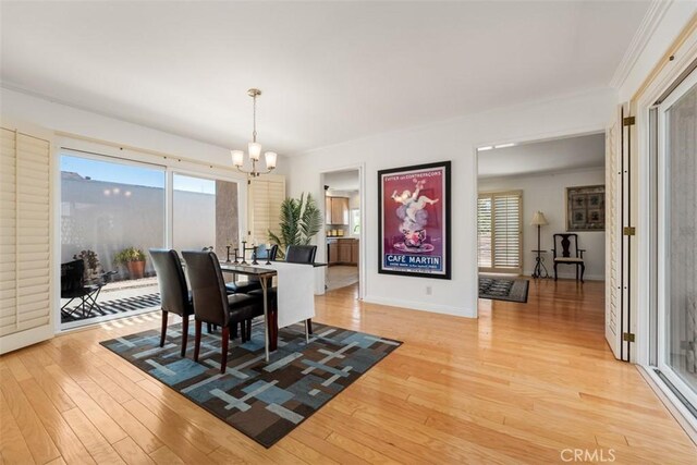 5231 Hiram Ln, Irvine, CA 92603 - dining space with a chandelier, light wood-style flooring, healthy amount of natural light, and ornamental molding