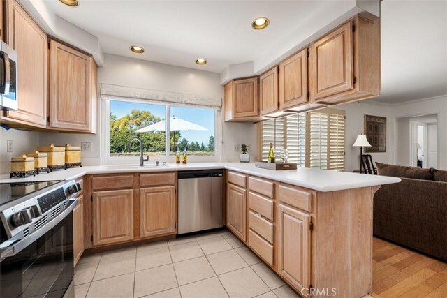 5231 Hiram Ln, Irvine, CA 92603 - kitchen featuring appliances with stainless steel finishes, a peninsula, open floor plan, light countertops, and recessed lighting