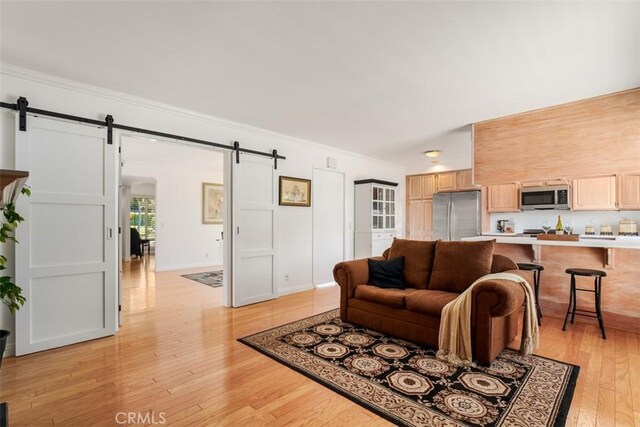 5231 Hiram Ln, Irvine, CA 92603 - living room with a barn door, light wood-type flooring, and ornamental molding