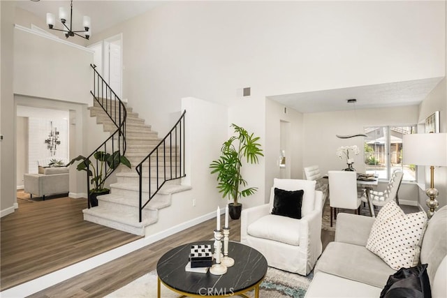 19 Jefferson, Irvine, CA 92620 - living area with a chandelier, stairs, wood finished floors, and a towering ceiling