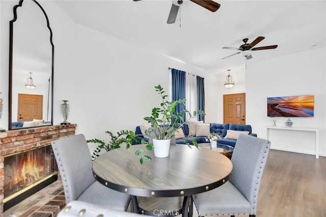 8103 David Way, Jurupa Valley, CA 92509 - dining area featuring ceiling fan, a brick fireplace, and wood finished floors