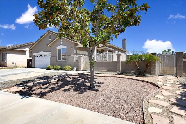 8103 David Way, Jurupa Valley, CA 92509 - view of front of property featuring a gate, concrete driveway, an attached garage, and stucco siding