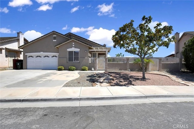 8103 David Way, Jurupa Valley, CA 92509 - view of front of home featuring a fenced front yard, a garage, stucco siding, concrete driveway, and a gate