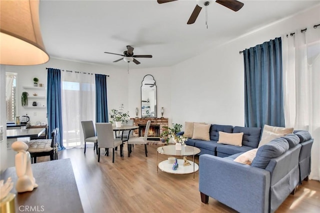 8103 David Way, Jurupa Valley, CA 92509 - living area with a ceiling fan, light wood finished floors, and a brick fireplace