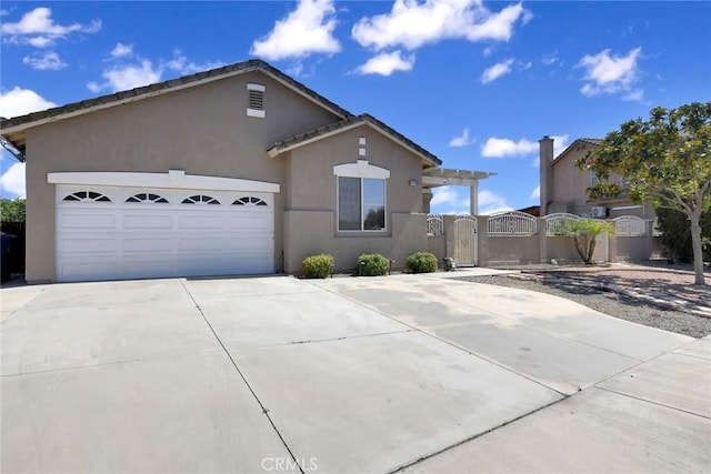8103 David Way, Jurupa Valley, CA 92509 - view of front of property featuring a gate, concrete driveway, stucco siding, and a garage