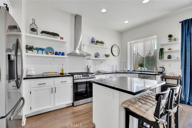 8103 David Way, Jurupa Valley, CA 92509 - kitchen featuring open shelves, stainless steel appliances, wall chimney range hood, dark countertops, and recessed lighting
