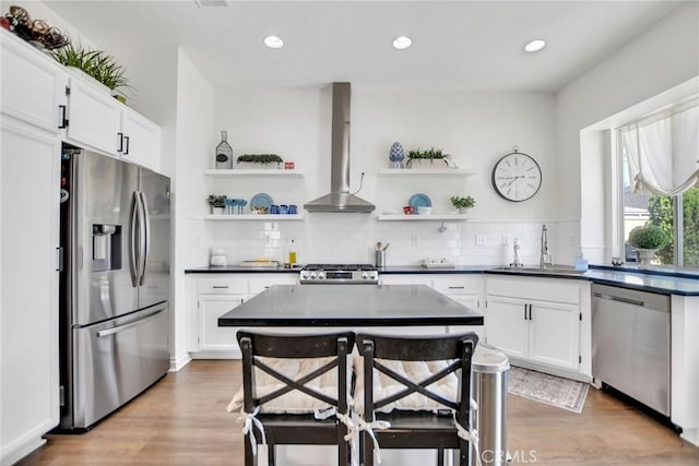 8103 David Way, Jurupa Valley, CA 92509 - kitchen with stainless steel appliances, open shelves, wall chimney range hood, dark countertops, and white cabinetry
