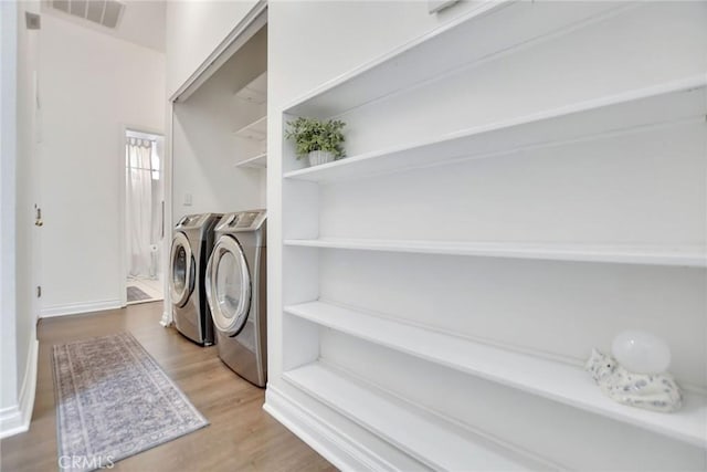 8103 David Way, Jurupa Valley, CA 92509 - washroom with separate washer and dryer and wood finished floors
