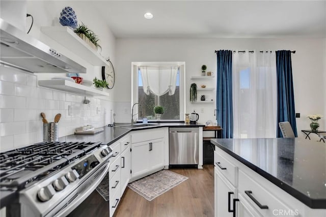 8103 David Way, Jurupa Valley, CA 92509 - kitchen with open shelves, stainless steel appliances, ventilation hood, wood finished floors, and recessed lighting