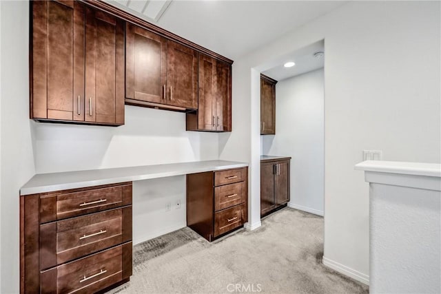 70 Linden Ln, Temple City, CA 91780 - kitchen with built in desk, light carpet, dark brown cabinetry, and light countertops