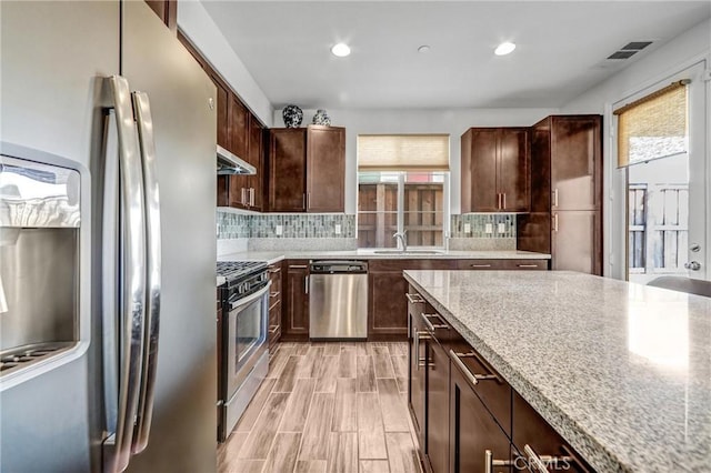 70 Linden Ln, Temple City, CA 91780 - kitchen featuring stainless steel appliances, healthy amount of natural light, under cabinet range hood, decorative backsplash, and recessed lighting