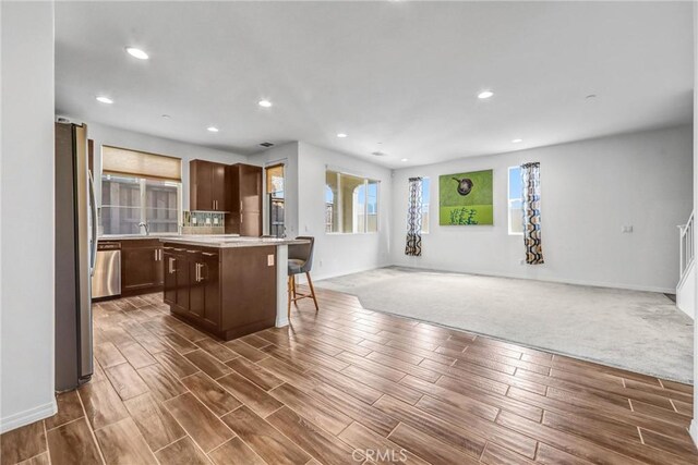 70 Linden Ln, Temple City, CA 91780 - kitchen with a center island, open floor plan, freestanding refrigerator, light countertops, and dark brown cabinets