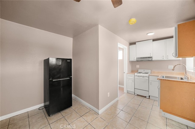 610 W Glen Lyn Dr, Glendora, CA 91740 - kitchen with white range, freestanding refrigerator, under cabinet range hood, white cabinetry, and light tile patterned floors