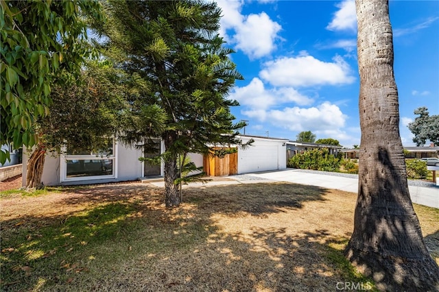 610 W Glen Lyn Dr, Glendora, CA 91740 - view of property hidden behind natural elements with driveway, an attached garage, and stucco siding