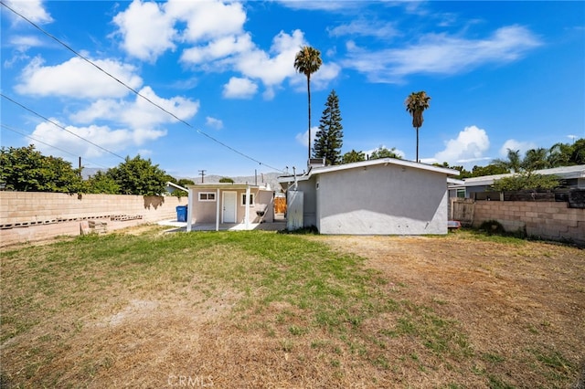610 W Glen Lyn Dr, Glendora, CA 91740 - rear view of house with a fenced backyard, stucco siding, and an outbuilding