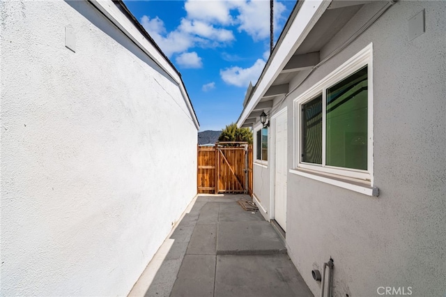 610 W Glen Lyn Dr, Glendora, CA 91740 - view of property exterior with stucco siding, a gate, and a patio