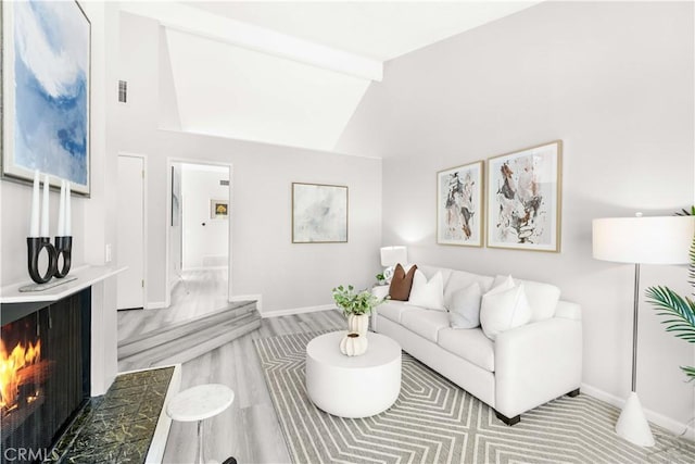 90 Lakepines Unit 5B, Irvine, CA 92620 - living area featuring a lit fireplace and baseboards