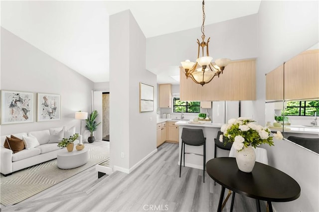 90 Lakepines Unit 5B, Irvine, CA 92620 - living room with high vaulted ceiling, a chandelier, and light wood-style floors