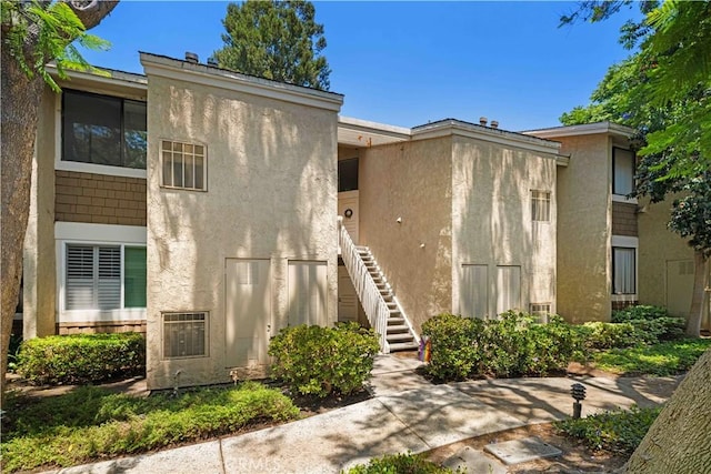 90 Lakepines Unit 5B, Irvine, CA 92620 - view of front of property with stairs and stucco siding