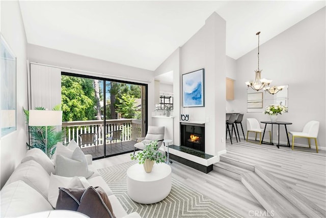 90 Lakepines Unit 5B, Irvine, CA 92620 - living area with a chandelier, high vaulted ceiling, wood finished floors, and a multi sided fireplace