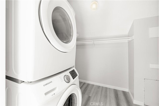 90 Lakepines Unit 5B, Irvine, CA 92620 - laundry area featuring stacked washer / drying machine and wood finished floors