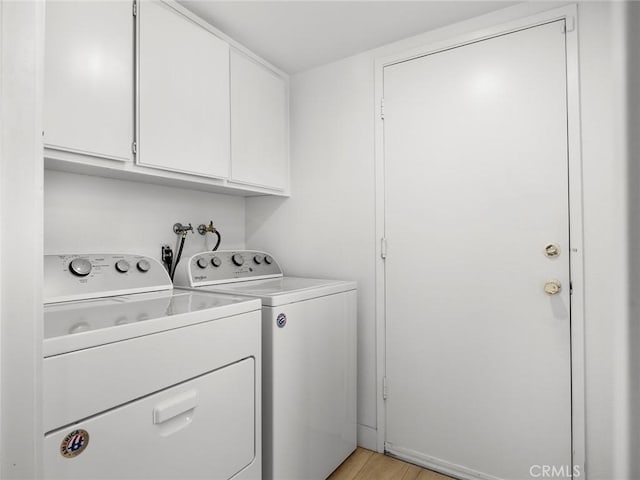 1324 Windermere Ct, Palmdale, CA 93551 - washroom featuring washer and clothes dryer, cabinet space, and light wood-style floors
