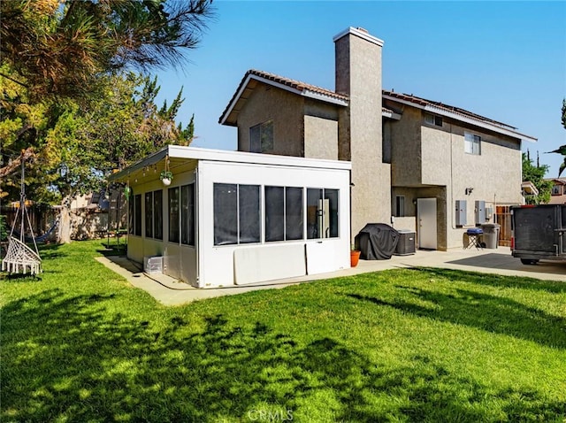1324 Windermere Ct, Palmdale, CA 93551 - back of house featuring a sunroom, a chimney, a patio area, and stucco siding