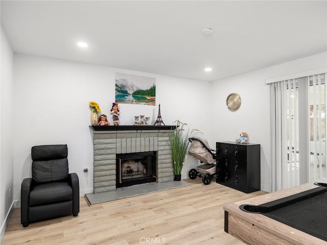 1324 Windermere Ct, Palmdale, CA 93551 - living room featuring wood finished floors, recessed lighting, and a brick fireplace