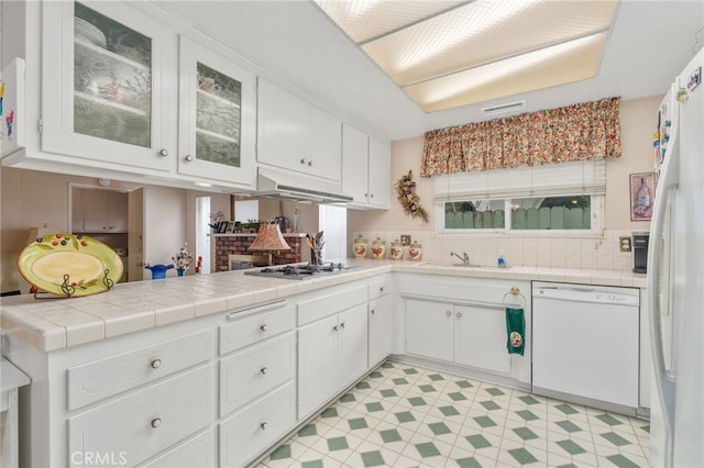 17655 Vine Ct, Fontana, CA 92335 - kitchen featuring white appliances, white cabinetry, under cabinet range hood, decorative backsplash, and light floors