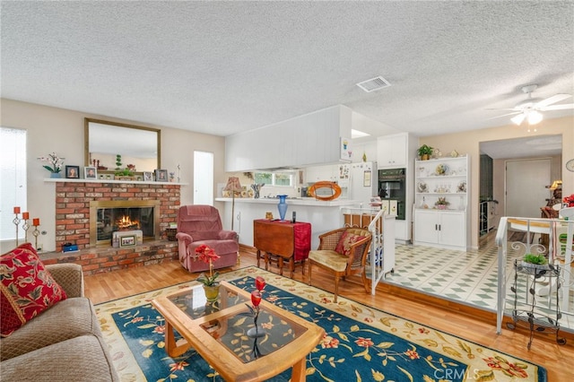 17655 Vine Ct, Fontana, CA 92335 - living room featuring plenty of natural light, light wood-style flooring, ceiling fan, and a textured ceiling