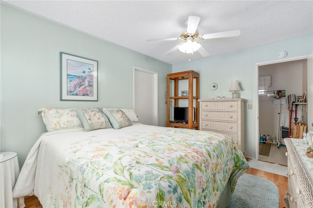 17655 Vine Ct, Fontana, CA 92335 - bedroom with light wood finished floors, a textured ceiling, and ceiling fan