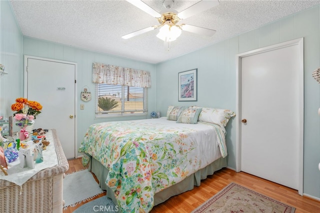 17655 Vine Ct, Fontana, CA 92335 - bedroom featuring wood finished floors, a textured ceiling, and ceiling fan