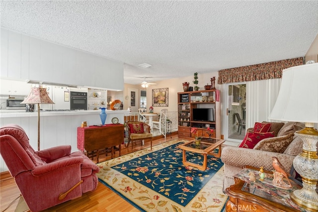 17655 Vine Ct, Fontana, CA 92335 - living area featuring wood finished floors, a textured ceiling, and ceiling fan