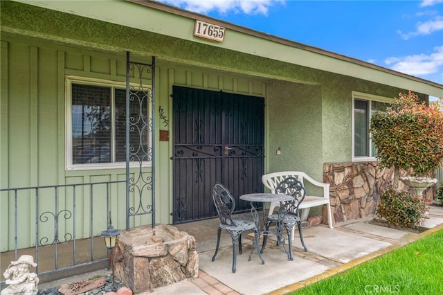 17655 Vine Ct, Fontana, CA 92335 - property entrance with stone siding, covered porch, and stucco siding