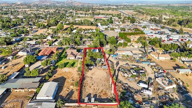 6093 Troth St, Jurupa Valley, CA 91752 - aerial view of property and surrounding area with property parcel outlined and a mountain backdrop