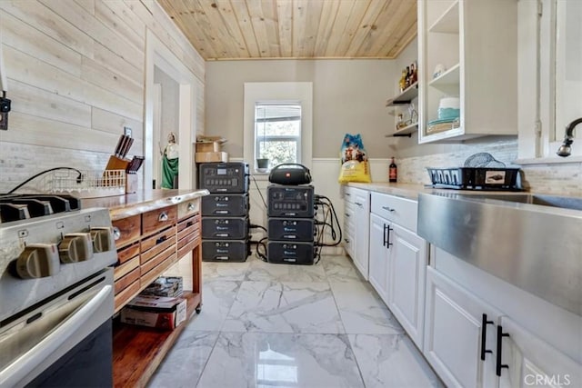 6093 Troth St, Jurupa Valley, CA 91752 - kitchen with wooden ceiling, stainless steel range oven, wood walls, light marble finish floors, and white cabinets