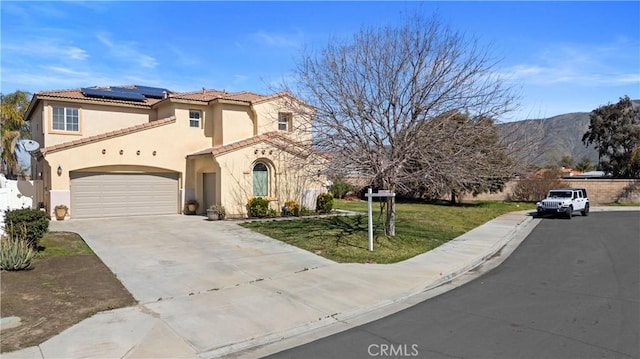 750 Multnomah Ct, San Jacinto, CA 92582 - view of front facade featuring stucco siding, solar panels, concrete driveway, a tiled roof, and a front lawn