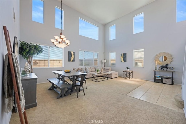 750 Multnomah Ct, San Jacinto, CA 92582 - dining space with carpet, a chandelier, a high ceiling, and tile patterned floors
