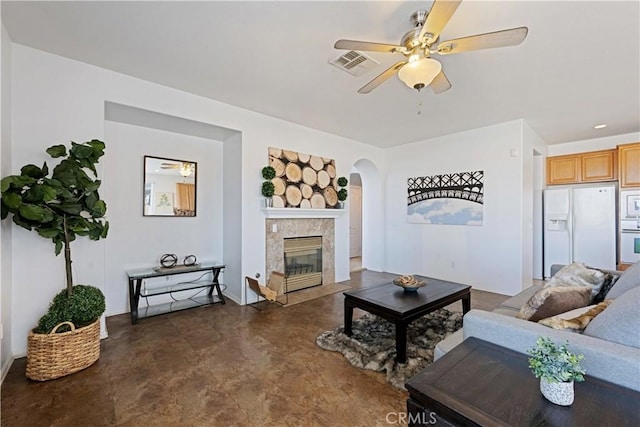 750 Multnomah Ct, San Jacinto, CA 92582 - living area with ceiling fan, arched walkways, finished concrete floors, and a tile fireplace