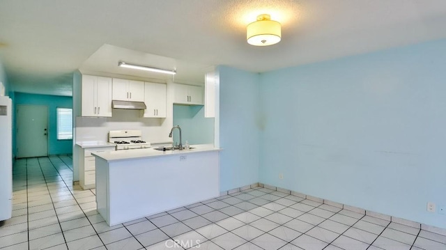 1531 E Ln Palma Ave Unit C2, Anaheim, CA 92805 - kitchen with white range with gas stovetop, under cabinet range hood, light countertops, white cabinetry, and light tile patterned floors