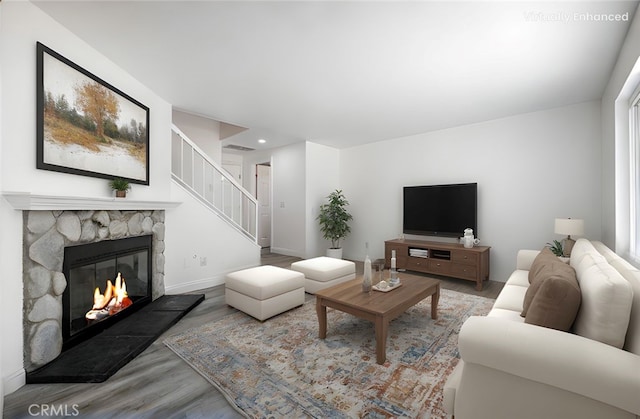 14791 Mountain High Dr, Fontana, CA 92337 - living room with wood finished floors, a fireplace, stairway, and recessed lighting