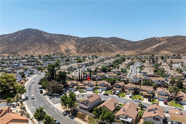 14791 Mountain High Dr, Fontana, CA 92337 - aerial view of property and surrounding area featuring nearby suburban area and a mountainous background