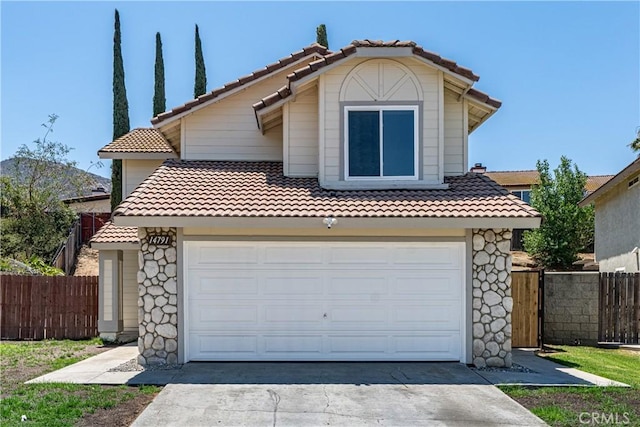 14791 Mountain High Dr, Fontana, CA 92337 - view of front of home with a tile roof, driveway, a garage, and stone siding